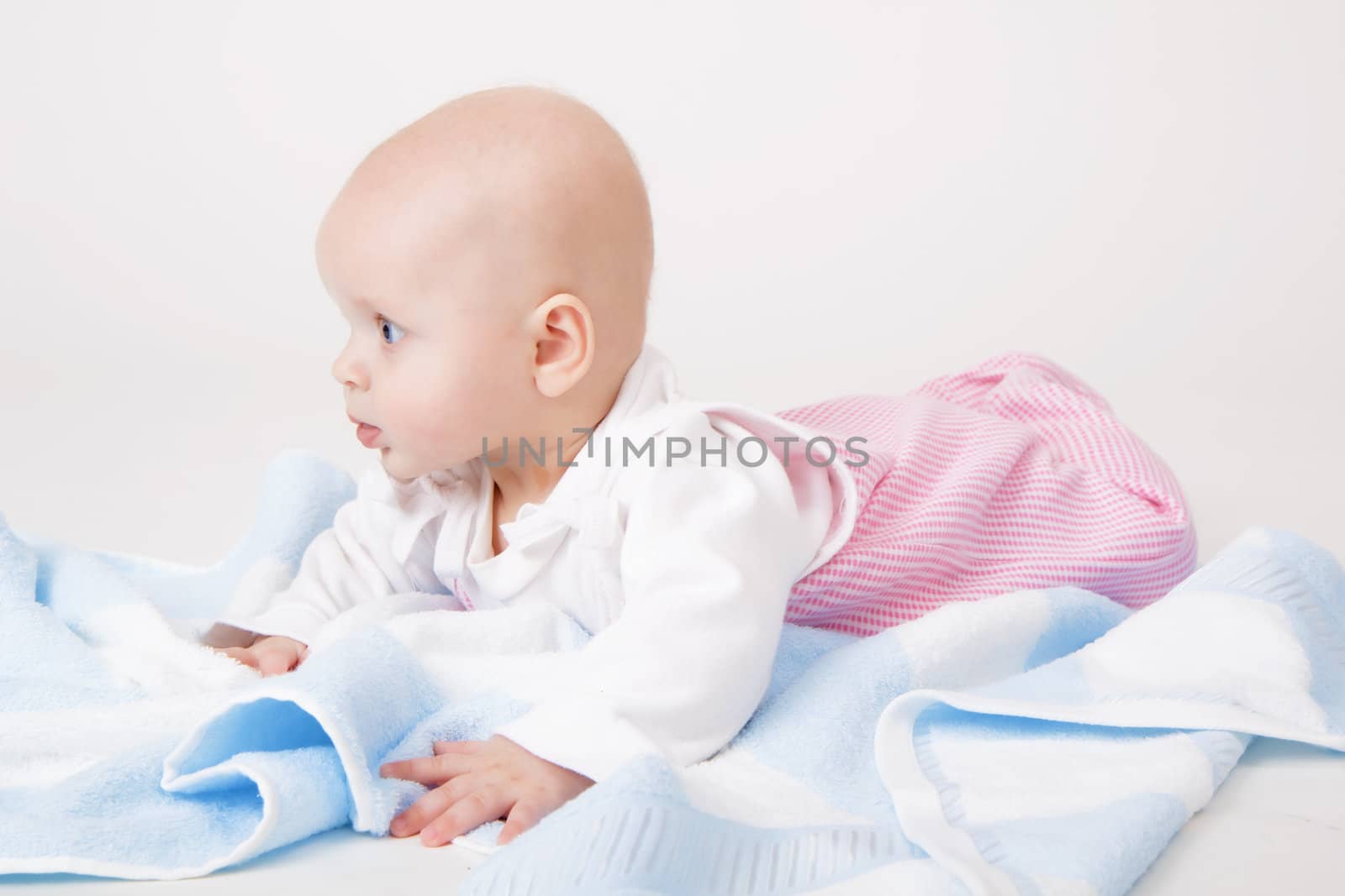 little girl with a blue towel. baby. Studio photography