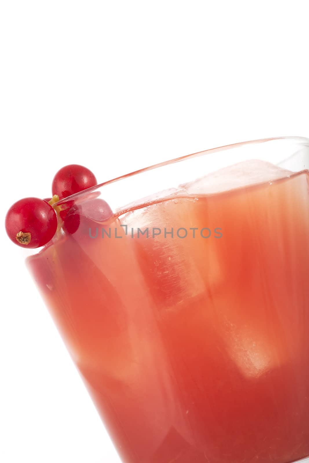 Fresh healthy red fruit juice with red currant garnish.