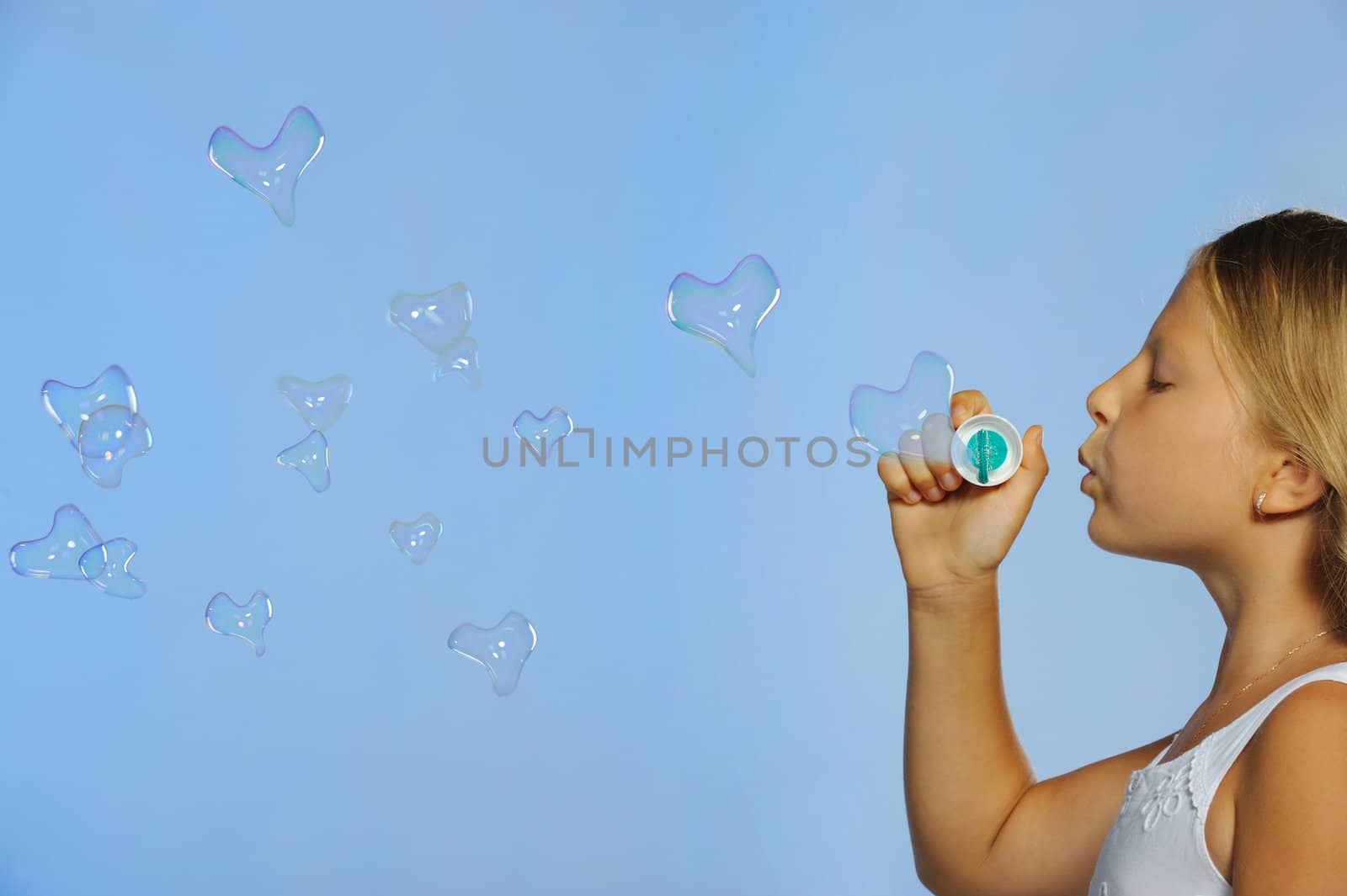The pretty girl with bubbles heart. A  blue background