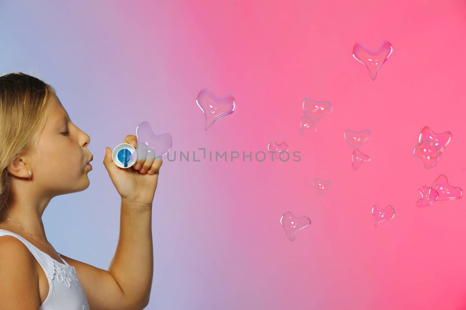 The pretty girl with bubbles heart. A  blue background