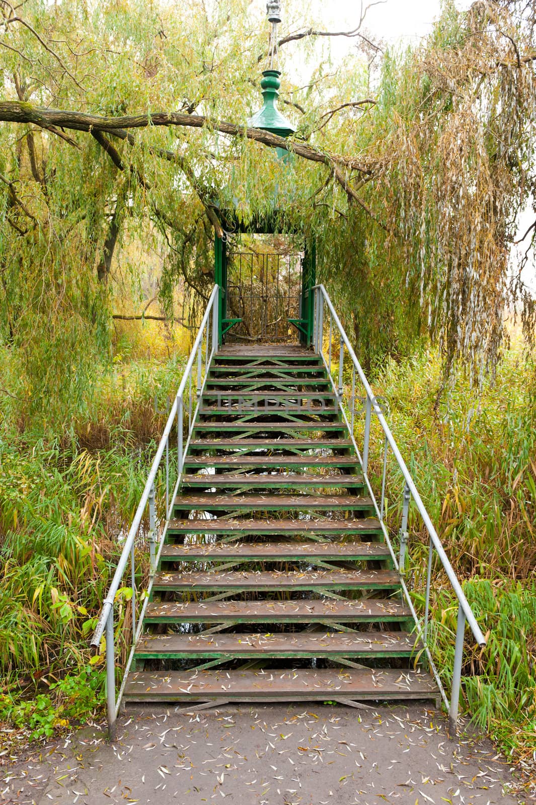 Iron ladder in summer house above a reservoir by galdzer