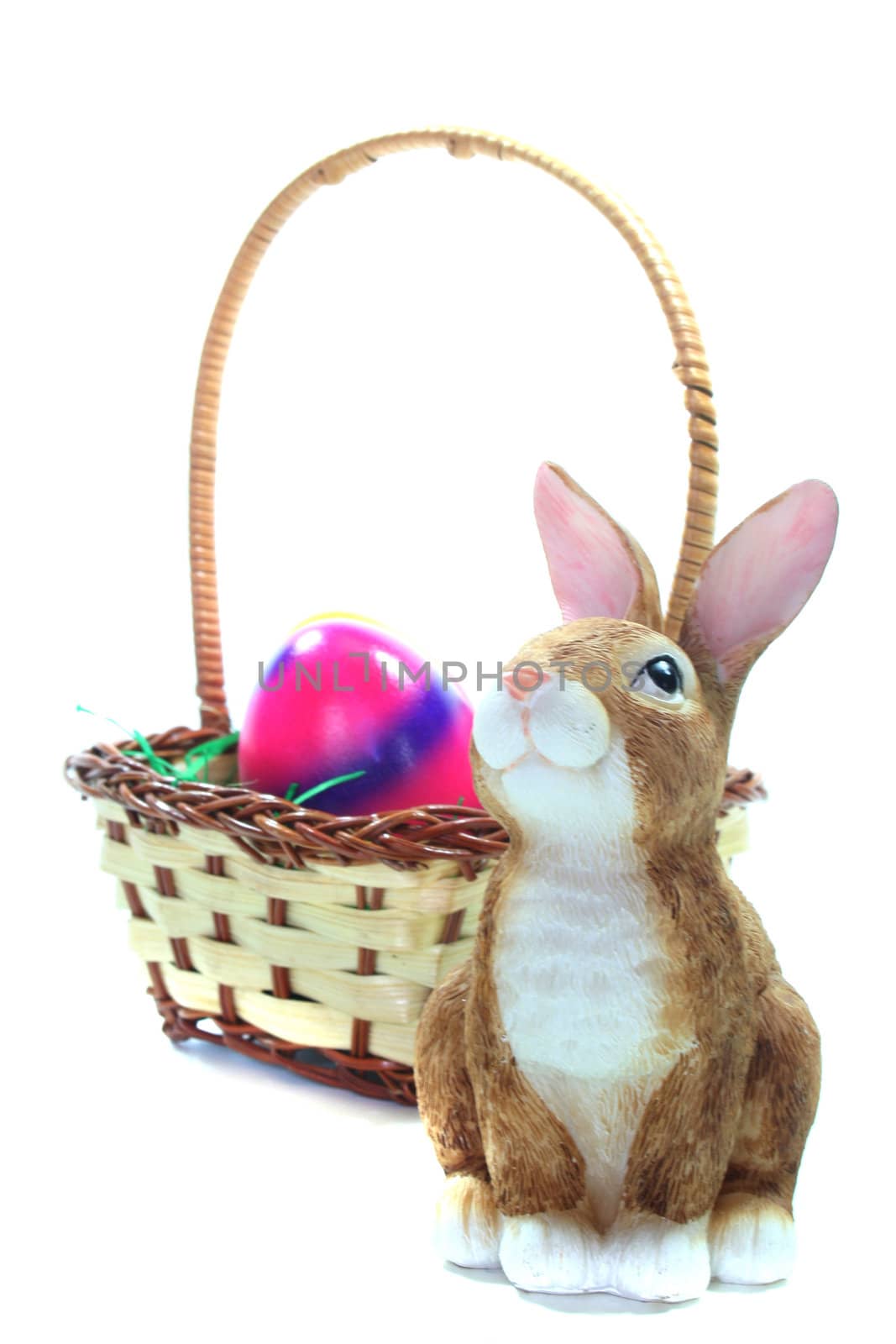Easter basket with Easter eggs and Easter bunny bright background