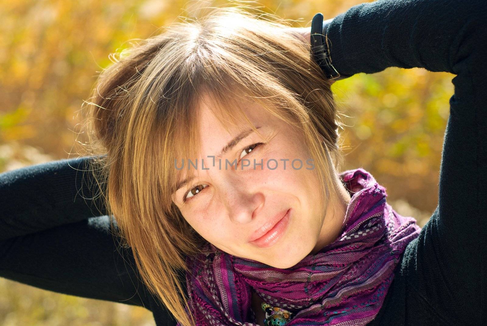 Portrait of smiling young beautiful woman outdoors