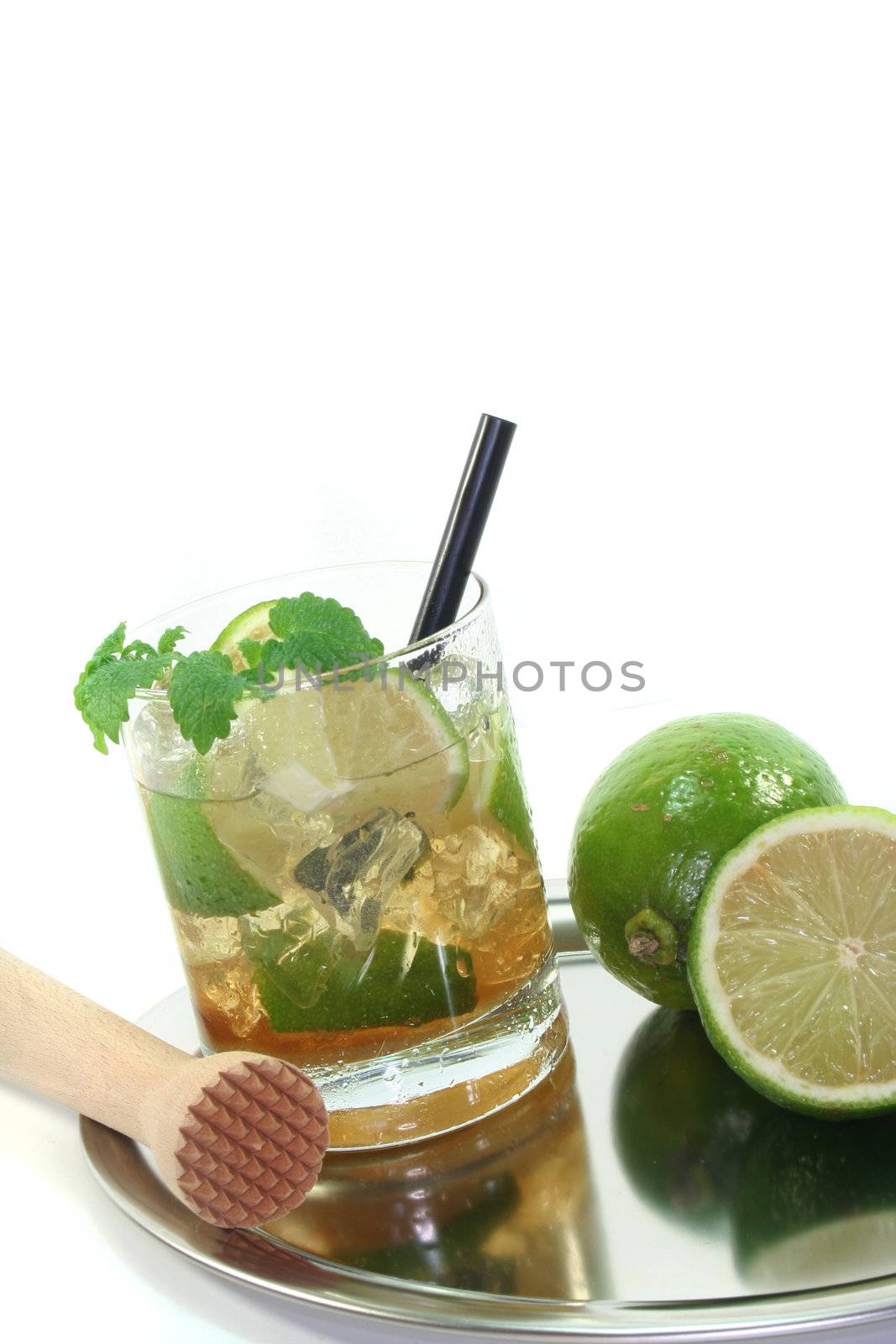 Mojito on a platter with fresh lime and lemon balm