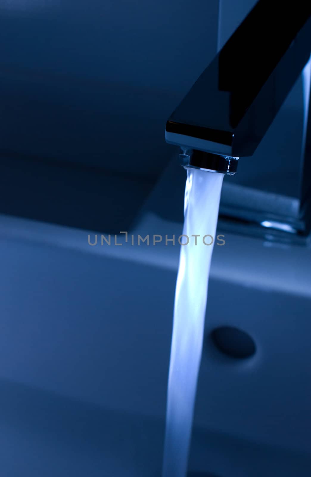 Closeup of modern bathroom tap in blue