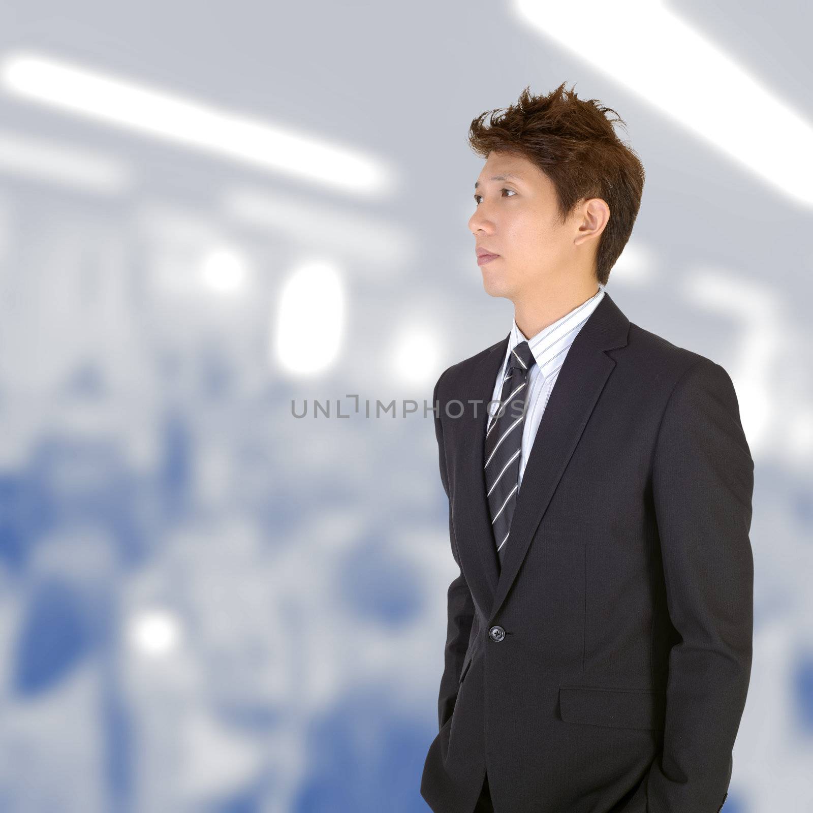 Worried young handsome executive of Asian in office.