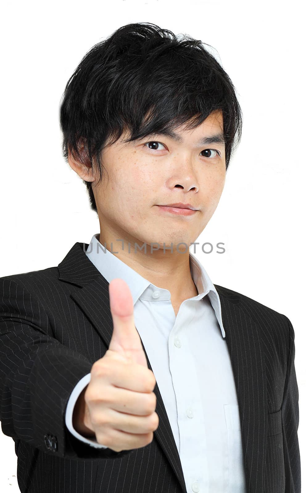 portrait of young man in suit and thumbs up