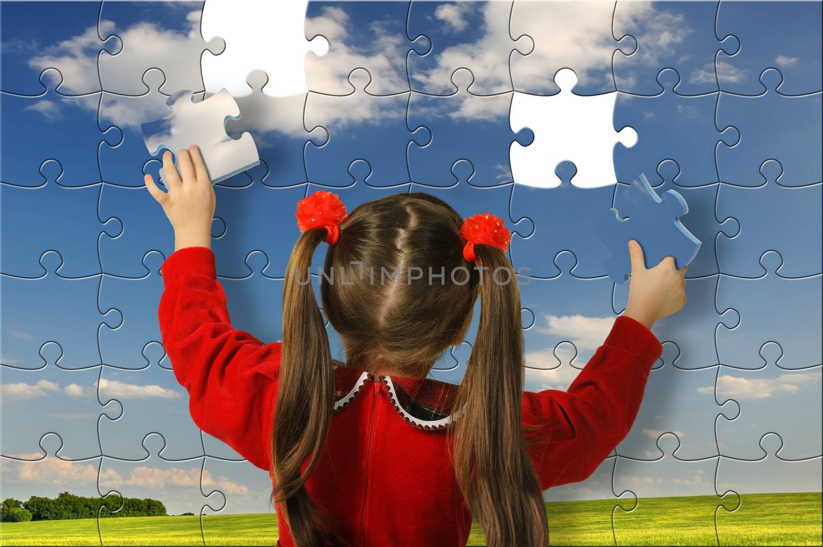 The girl assemble big puzzle. Landscape on a picture