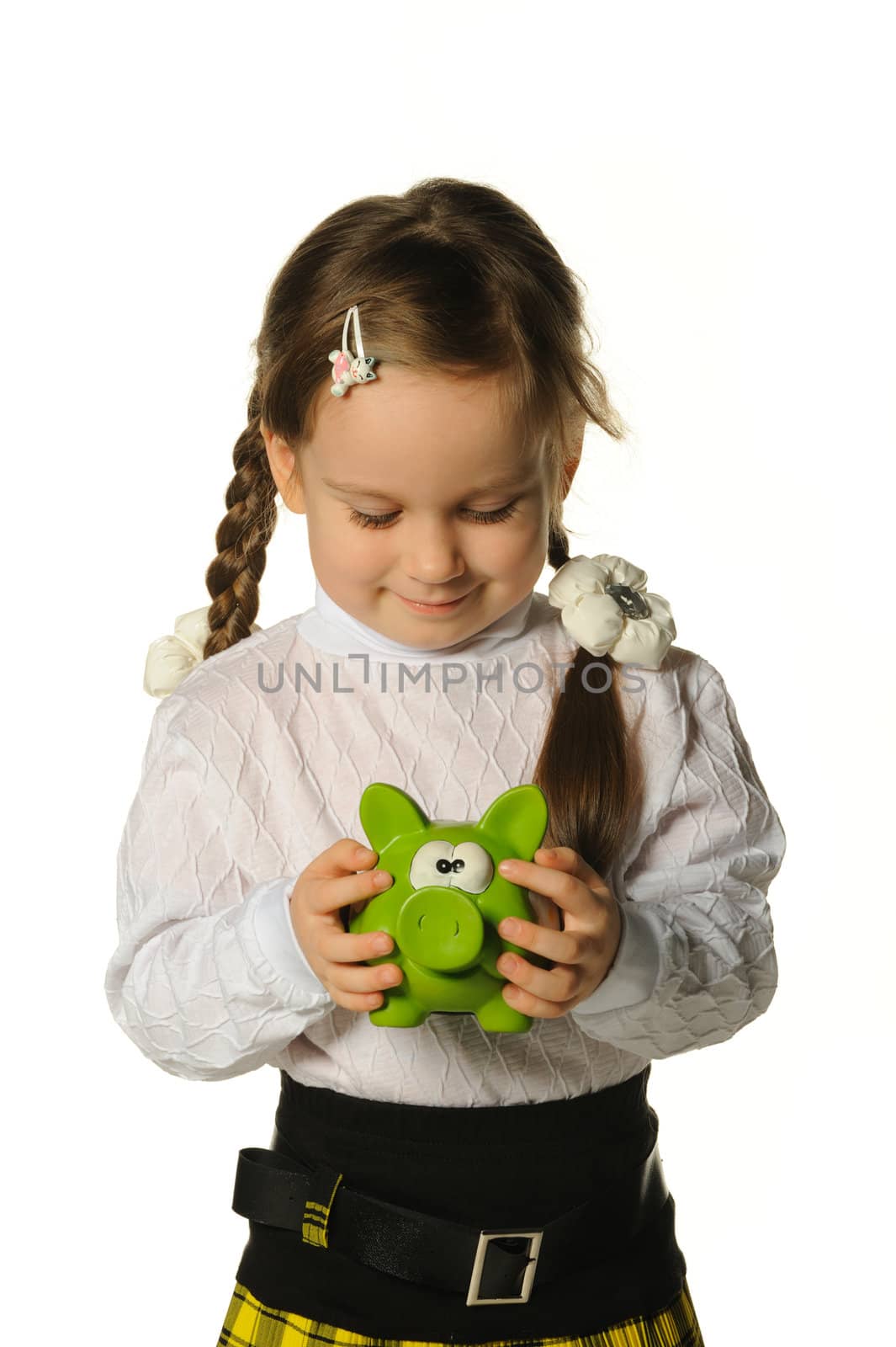 The little girl with a money box - a pig. It is isolated on a white background