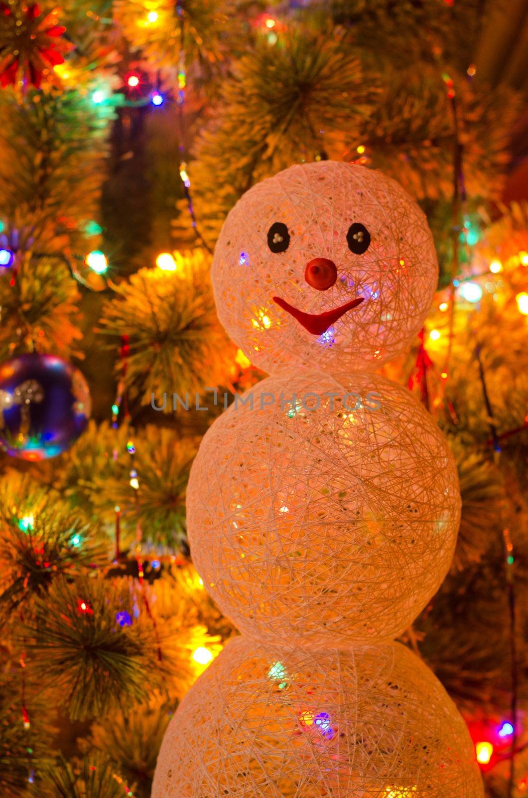 Beautiful Christmas fur-tree decorated with snowman toy