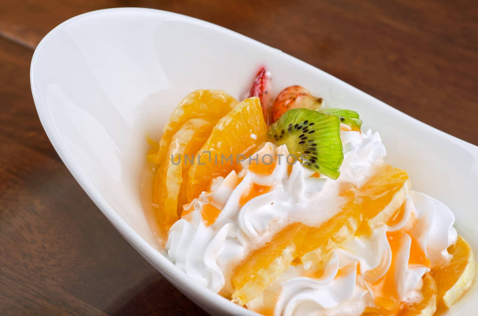 Ice cream dessert with kiwi, strawberry and orange