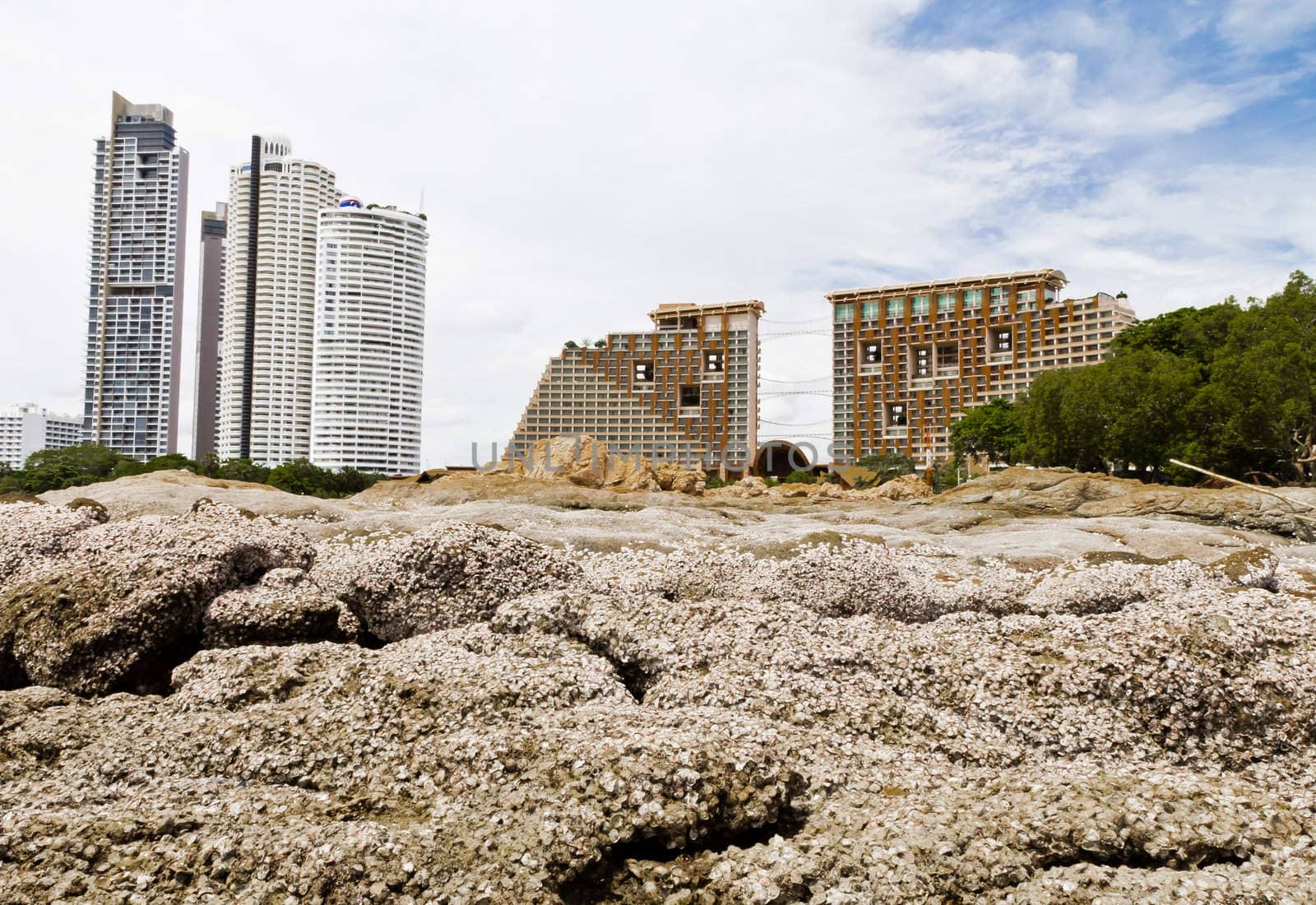 Beach, rocks, and hotels. The sea east of Thailand.