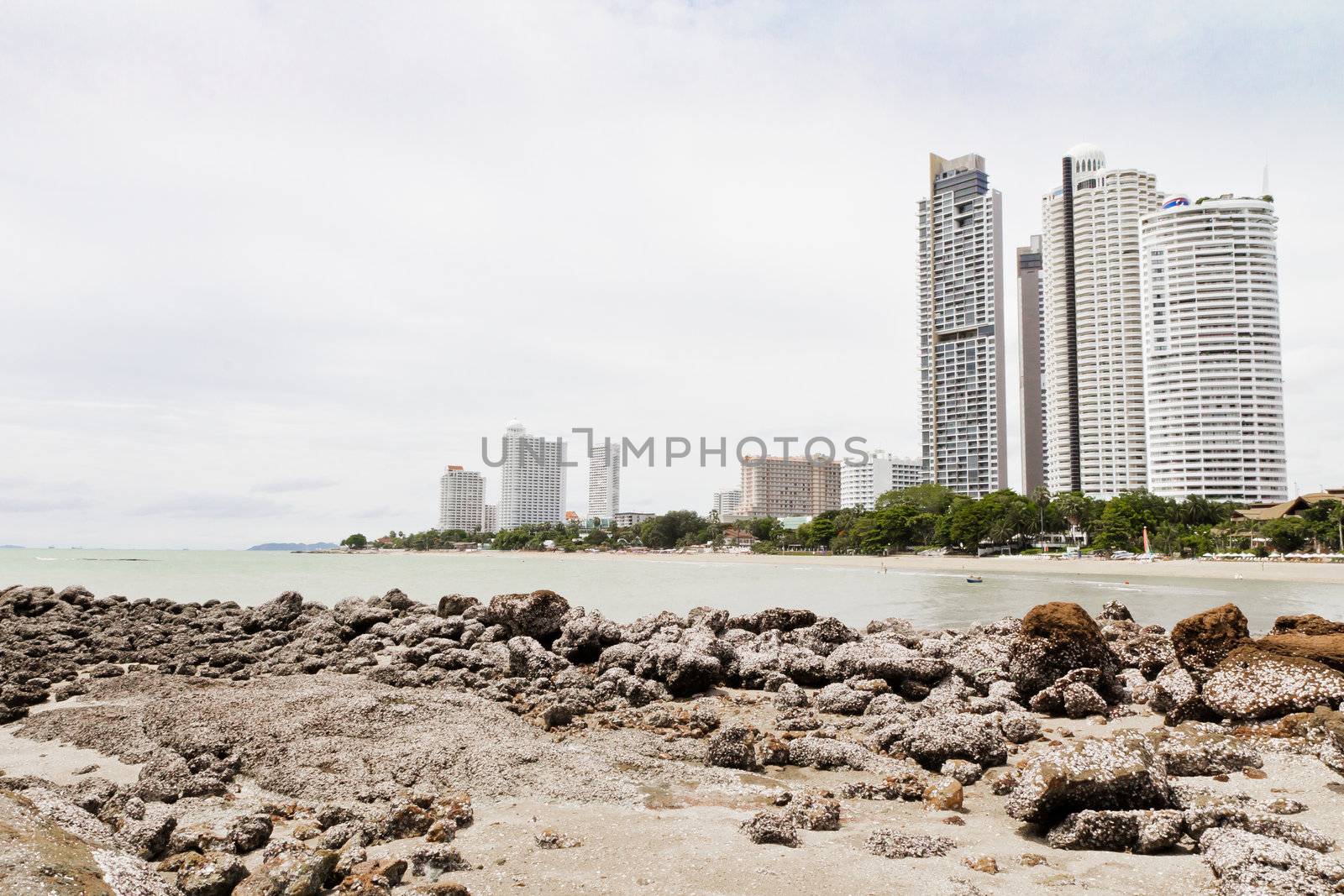 Beach, rocks, and hotels. The sea east of Thailand.