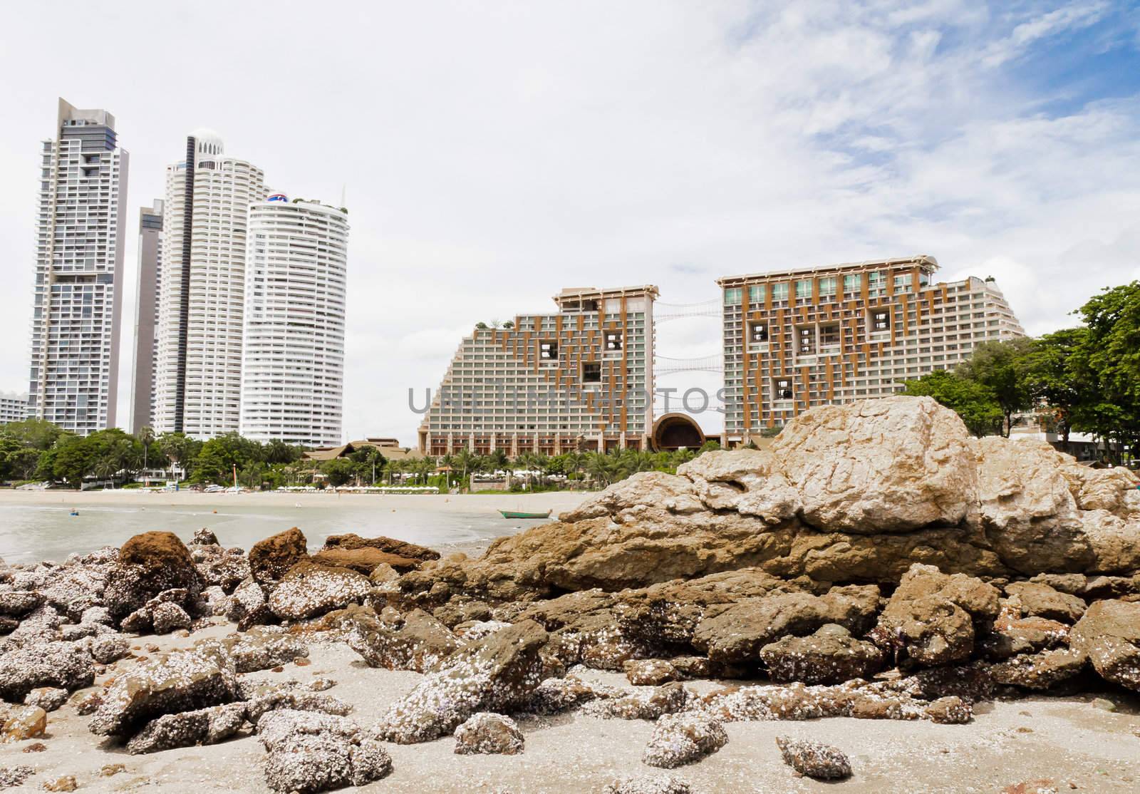 Beach, rocks, and hotels. The sea east of Thailand.