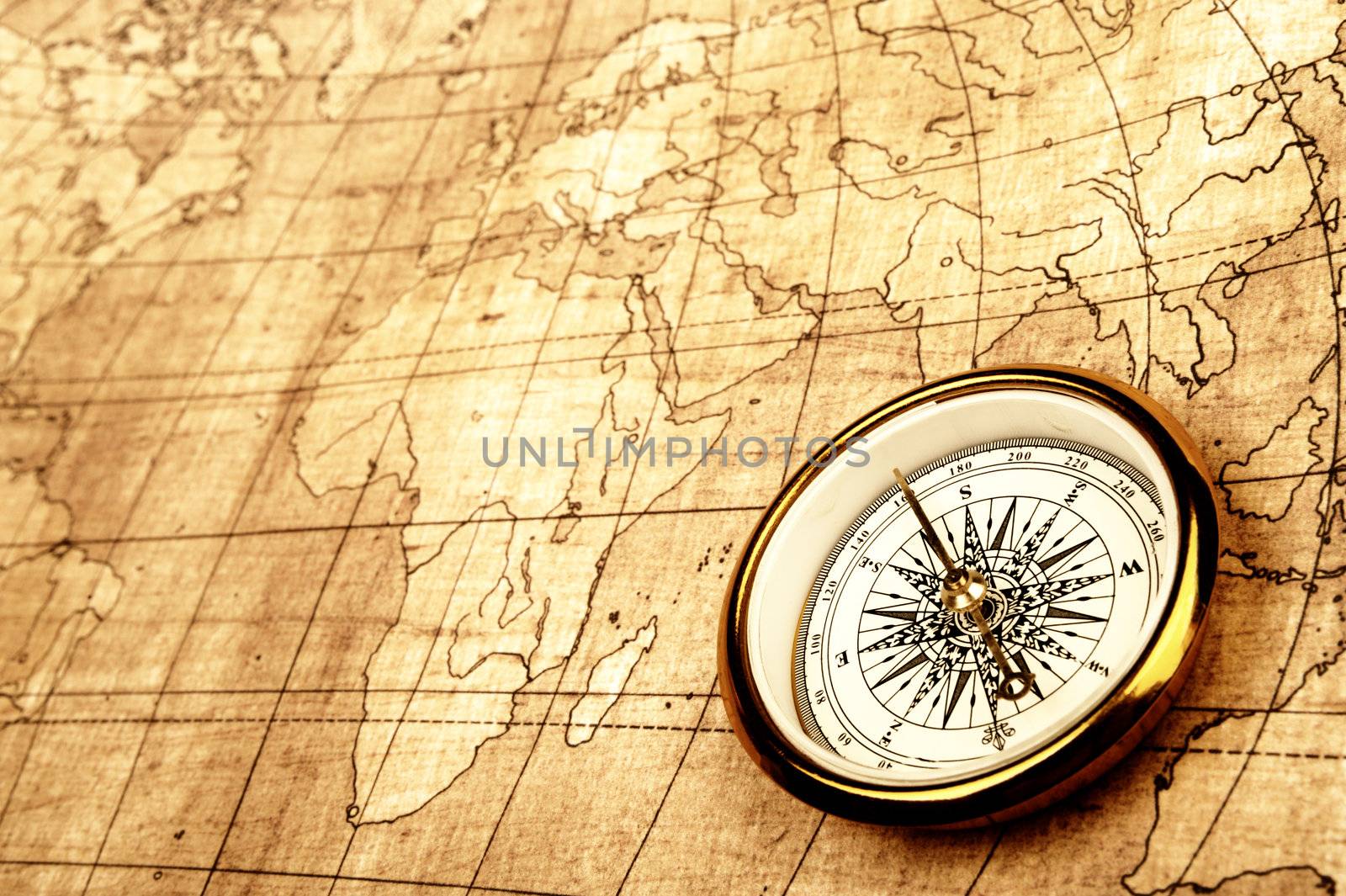 Compass on old map. Gold warm color tone