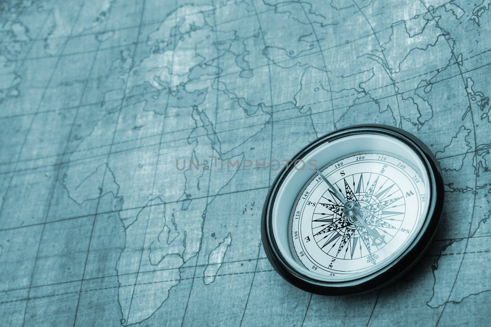 Compass on old map. Blue tone background