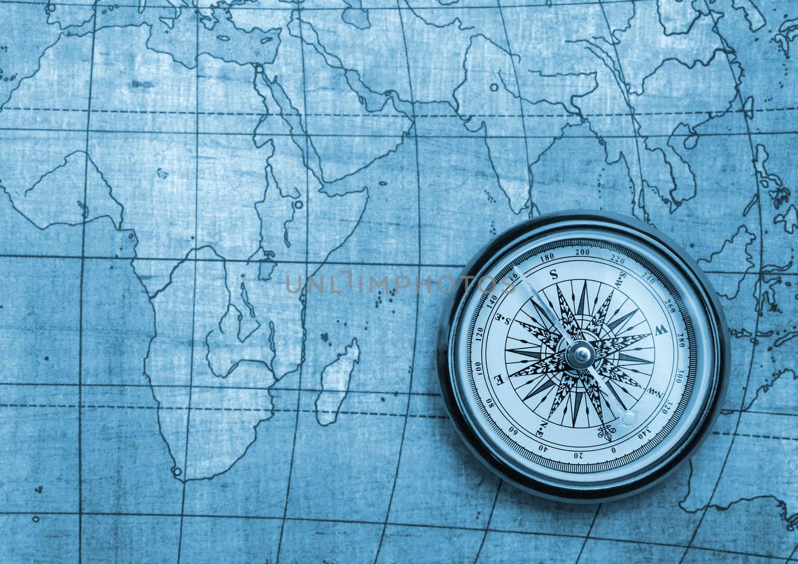 Compass on old map. Blue tone background