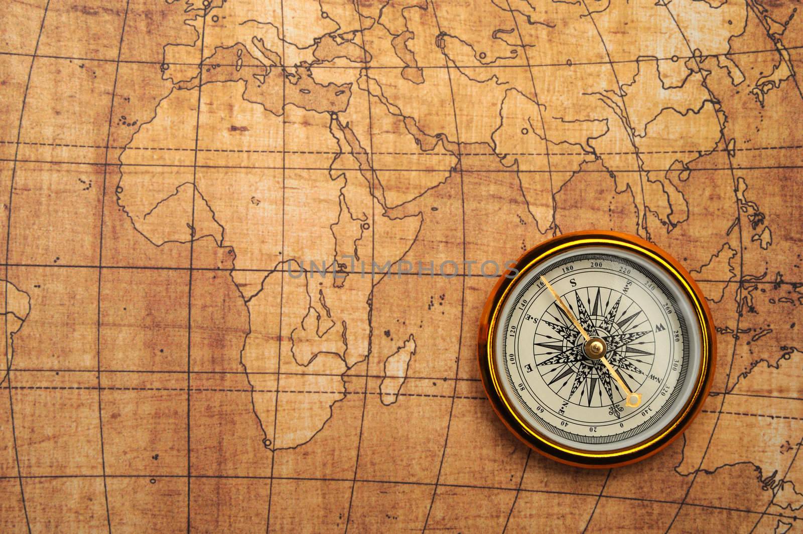 Compass on old map. Gold comapss and yellow map
