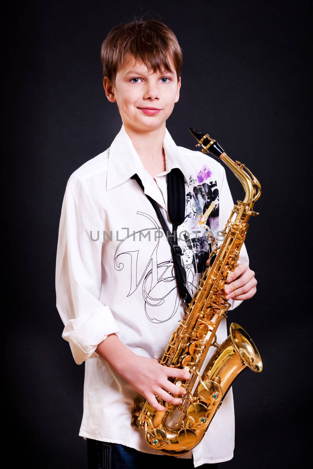 9 year old boy with a saxophone on black