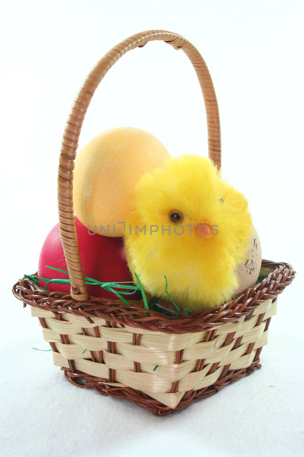 Easter basket with Easter eggs and chicks on a white background