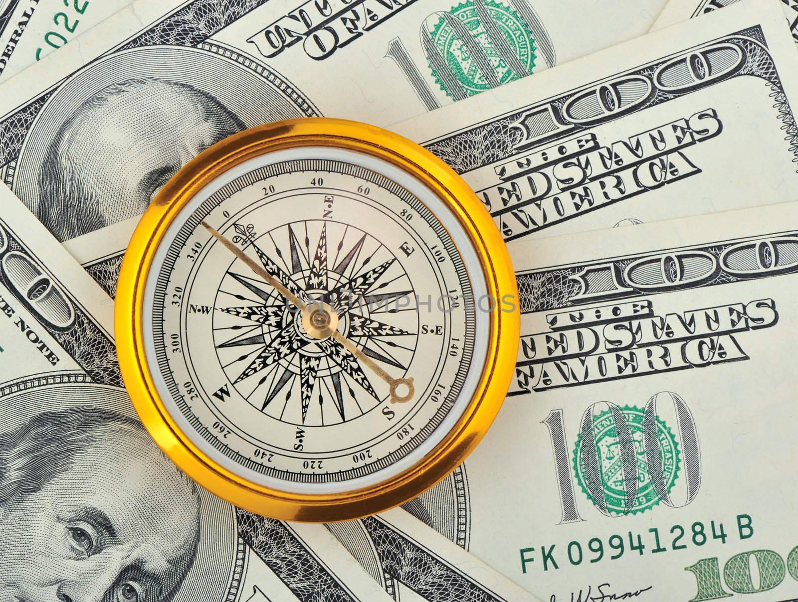 Dollars and compass. Concept about a direction in business
