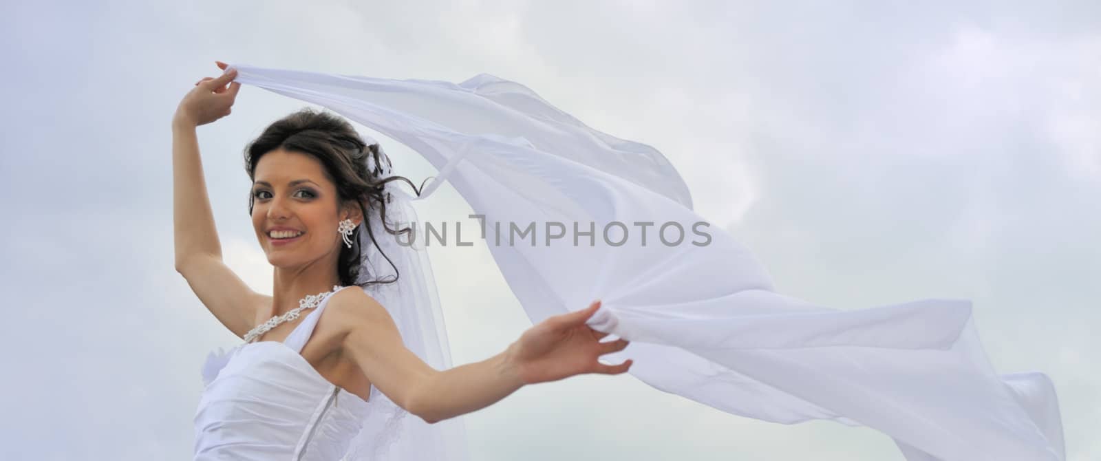 The bride with a fluttering veil. The young girl in a wedding dress.