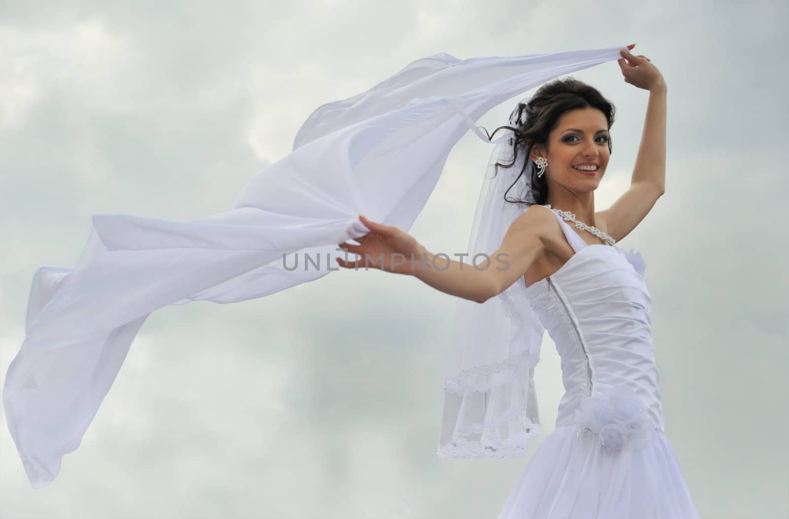 The bride with a fluttering veil. The young girl in a wedding dress.