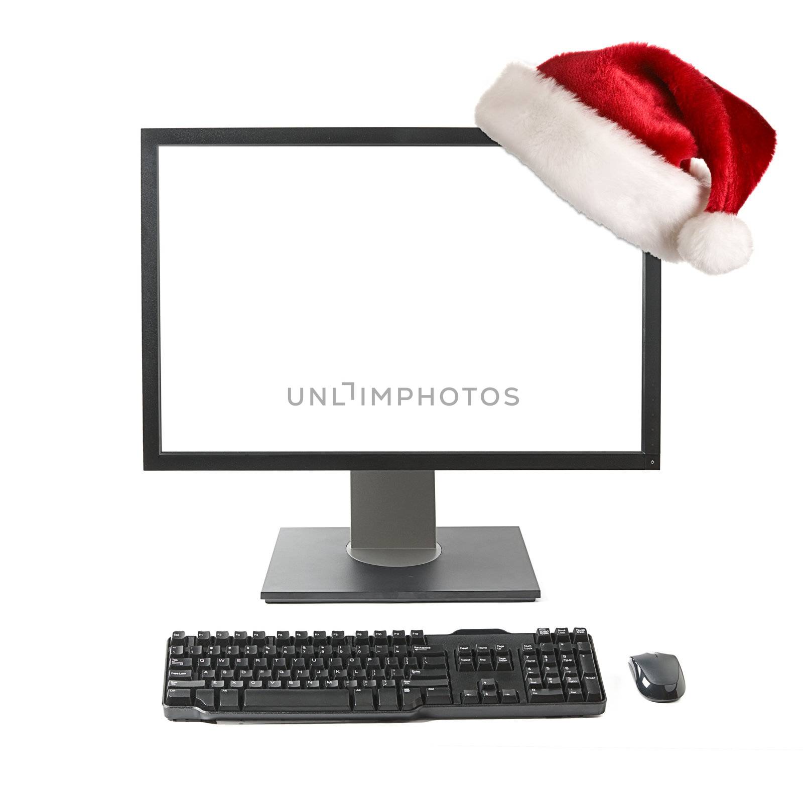 Cristmas online shopping concept - Computer workstation (monitor, keyboard, mouse) monitor with Santa hat   isolated on white background