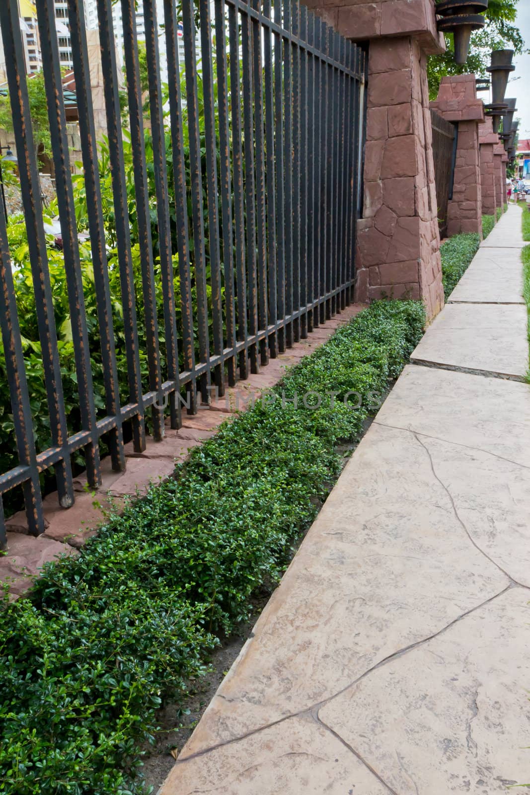 Walkway beside the fence, steel and stone walls of the hotel. by Na8011seeiN