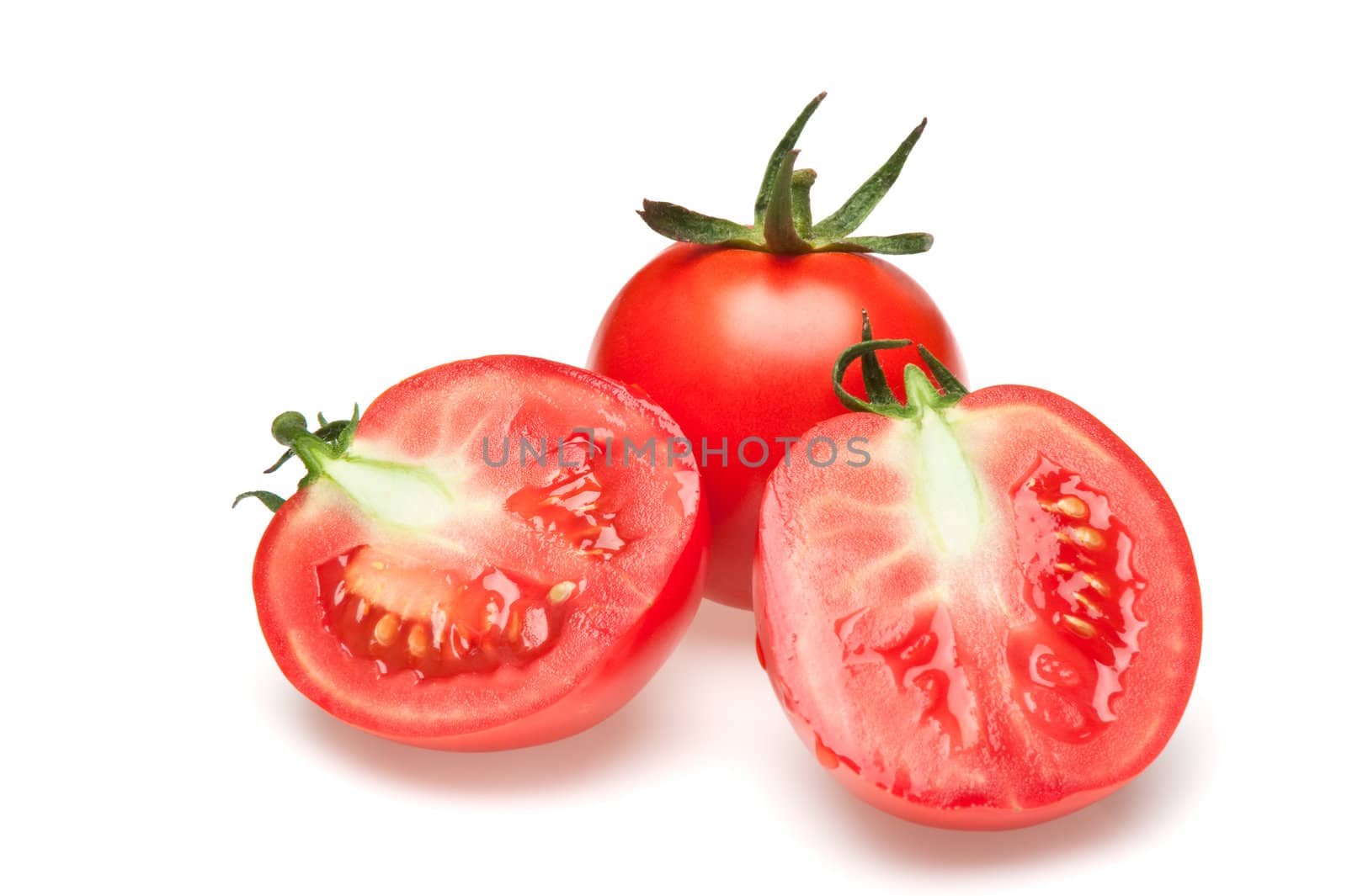 The cut tomatoes. It is isolated on a white background