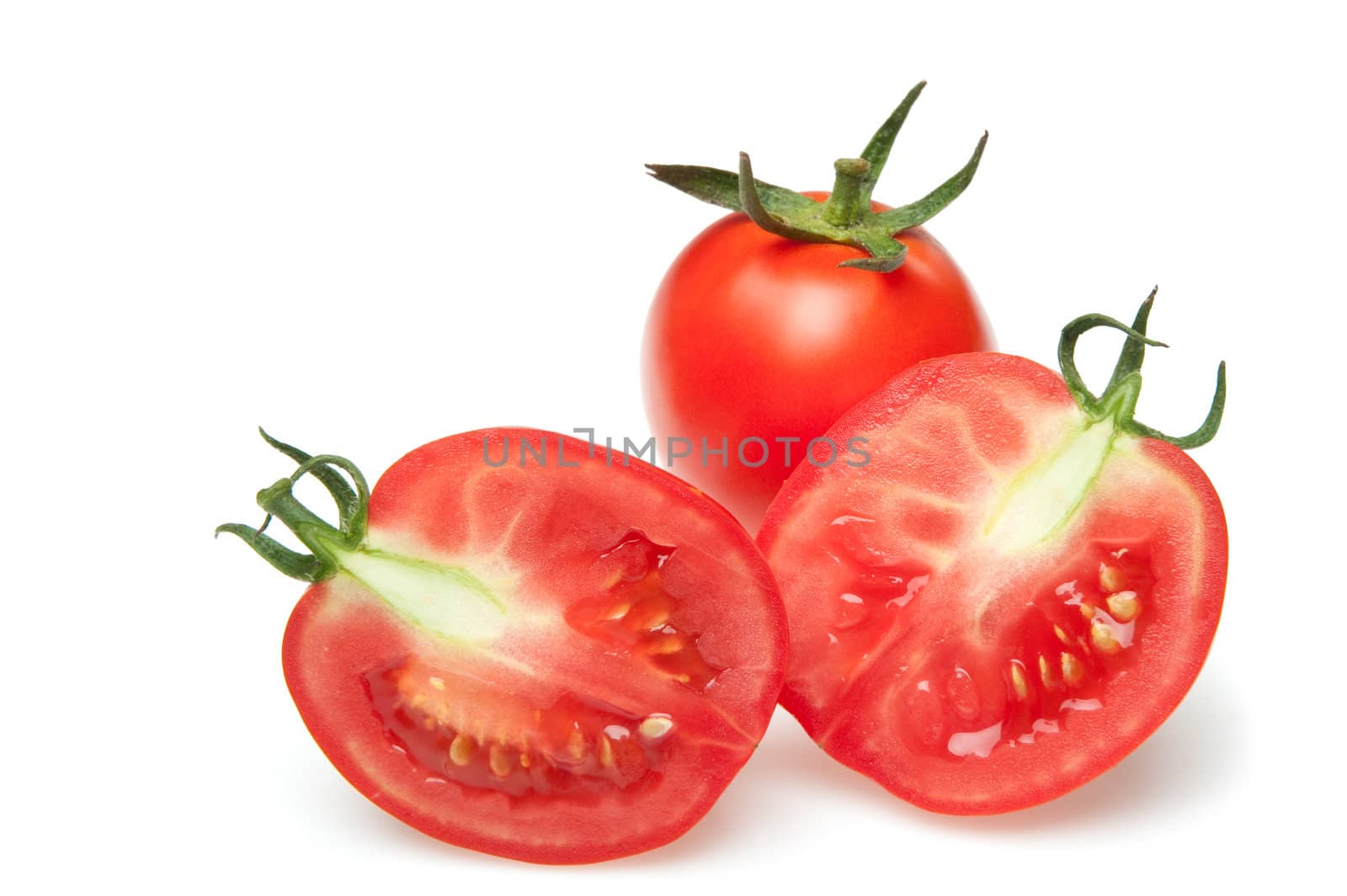 The cut tomatoes. It is isolated on a white background