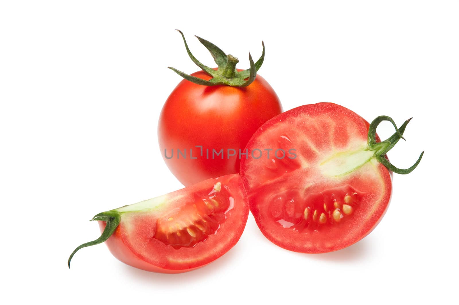 The cut tomatoes. It is isolated on a white background