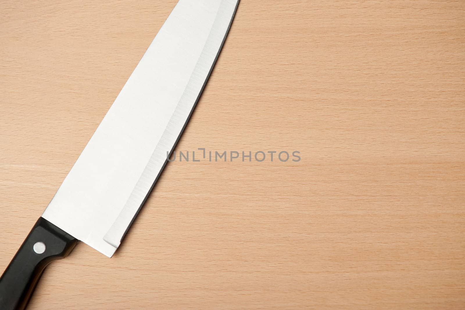 Knife and board for cutting food. Studio shooting.
