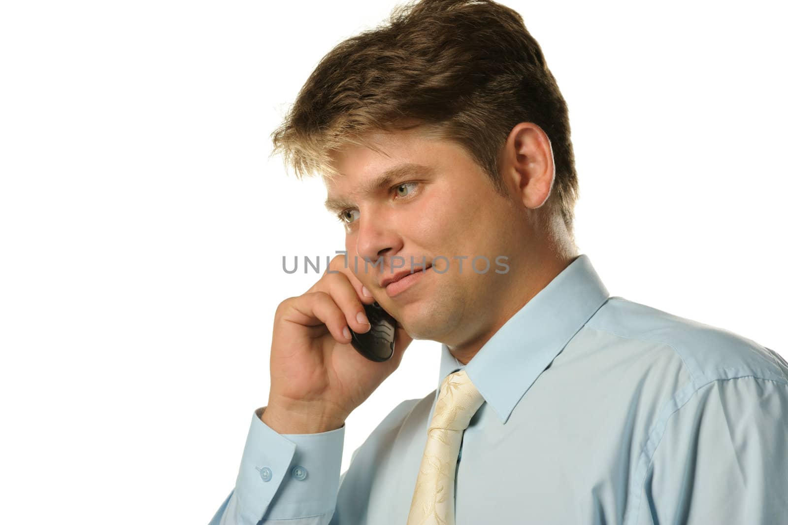 The businessman talking by a mobile phone. Young the man of the European appearance