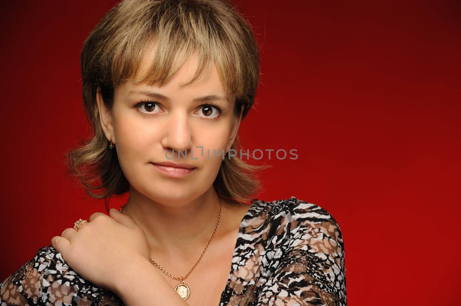 Portrait of the young girl on a red background. The European appearance