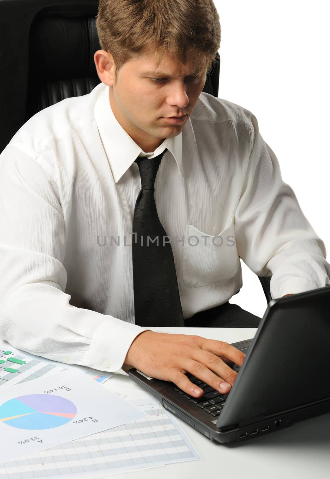 The young businessman on a workplace. It is isolated on a white background