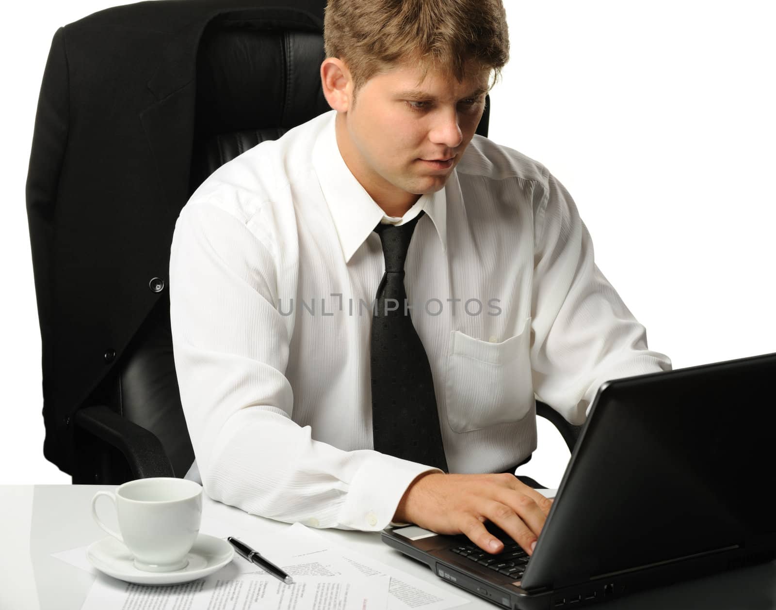 The young businessman on a workplace. It is isolated on a white background