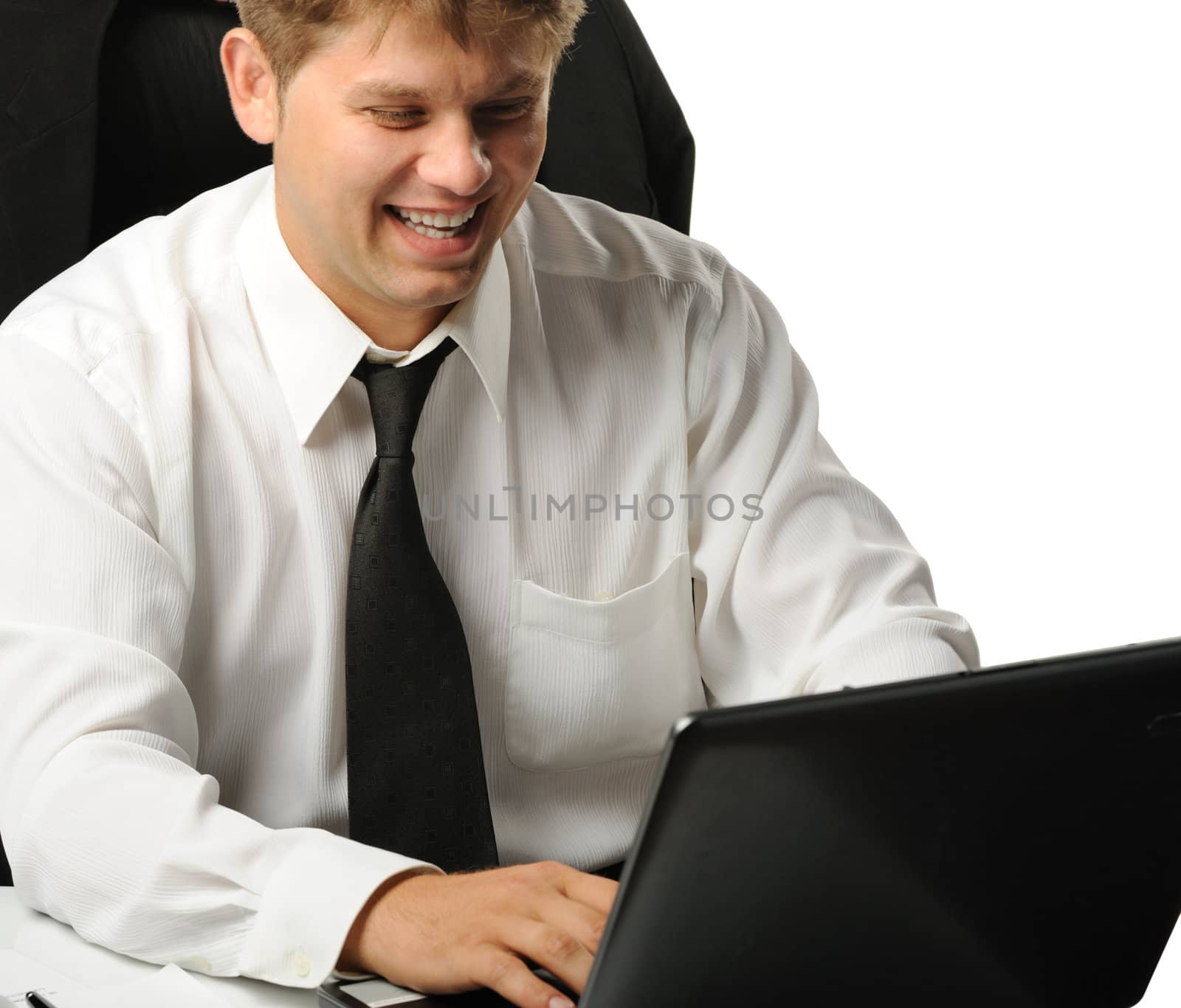 The young businessman on a workplace. It is isolated on a white background