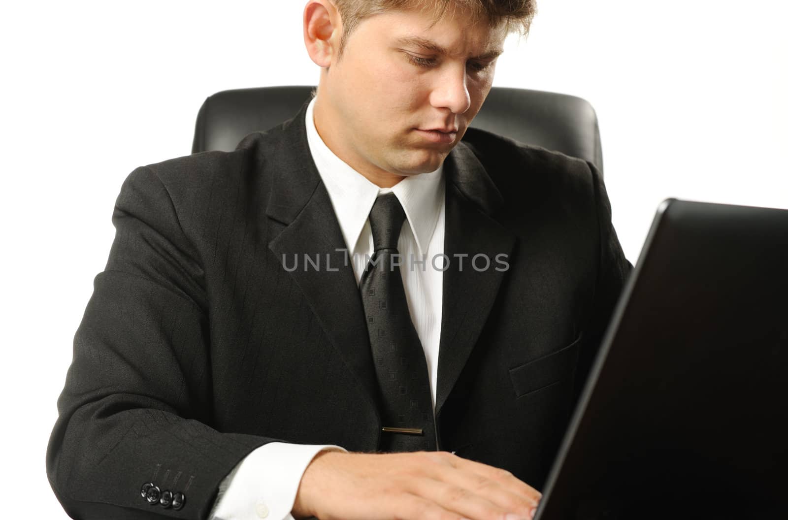 The young businessman on a workplace. It is isolated on a white background