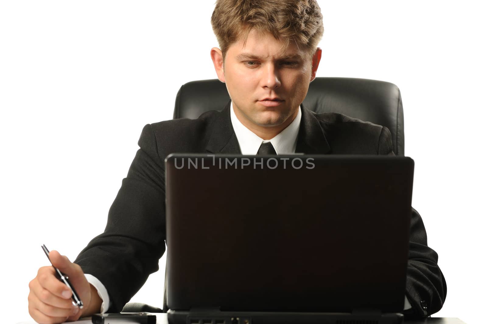 The young businessman on a workplace. It is isolated on a white background