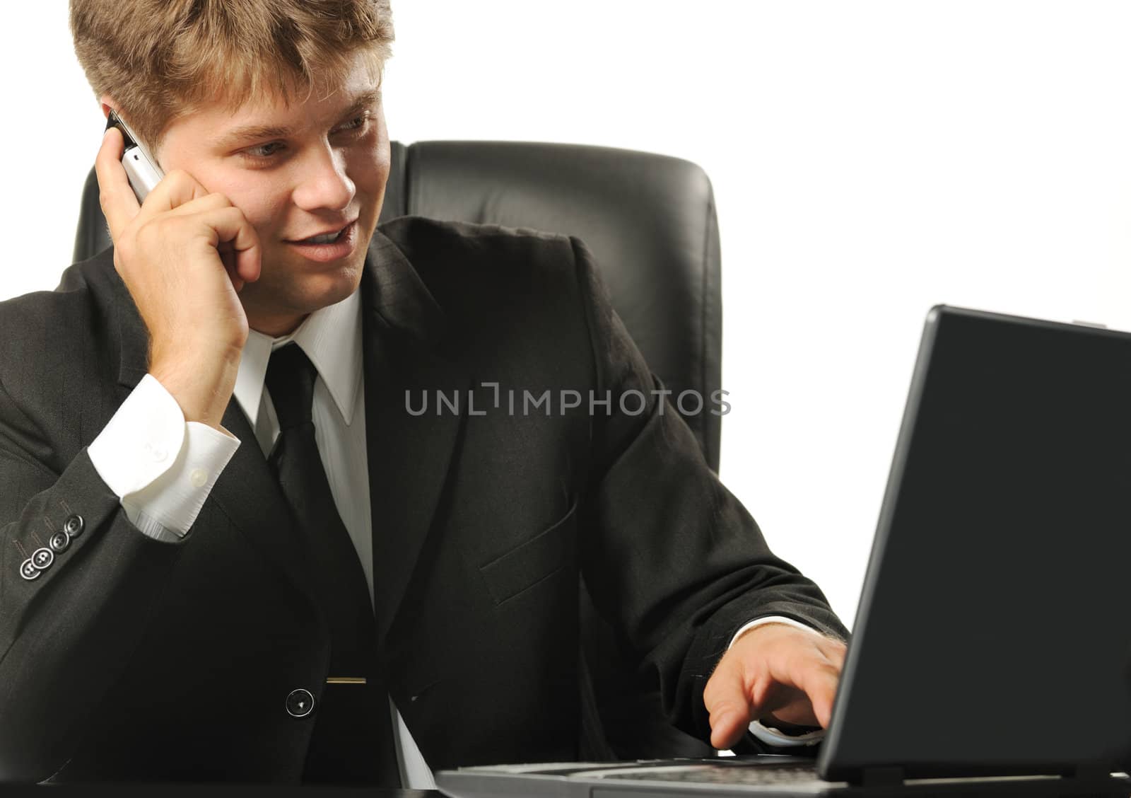 The young businessman on a workplace. It is isolated on a white background