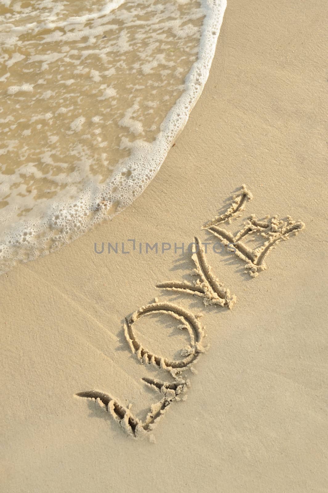 Inscription "love" on sand by galdzer