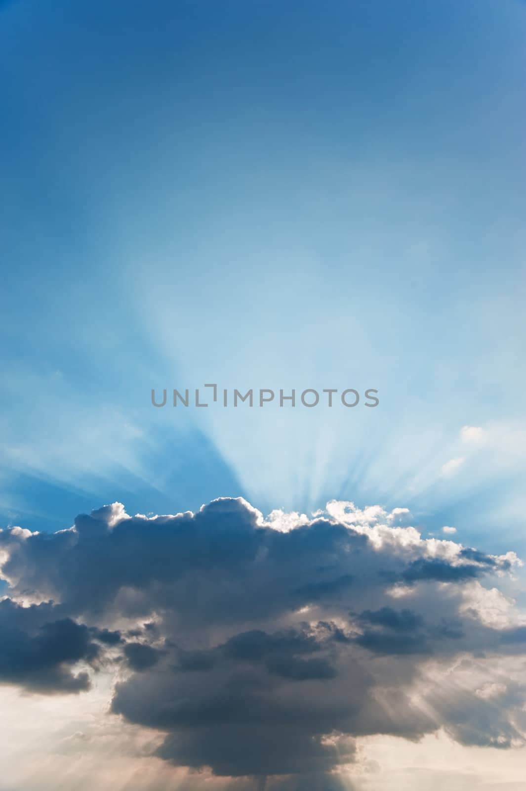 Cloud and beams of the sun. A greater thundercloud and beams of the sun because of it