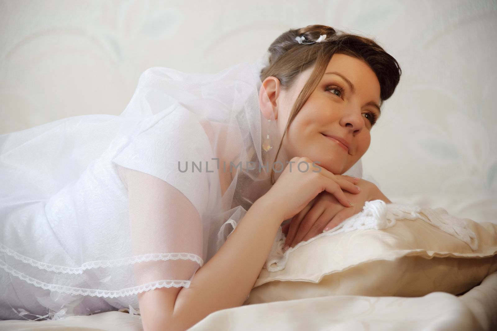 The bride. The young girl in a wedding dress on an abstract background