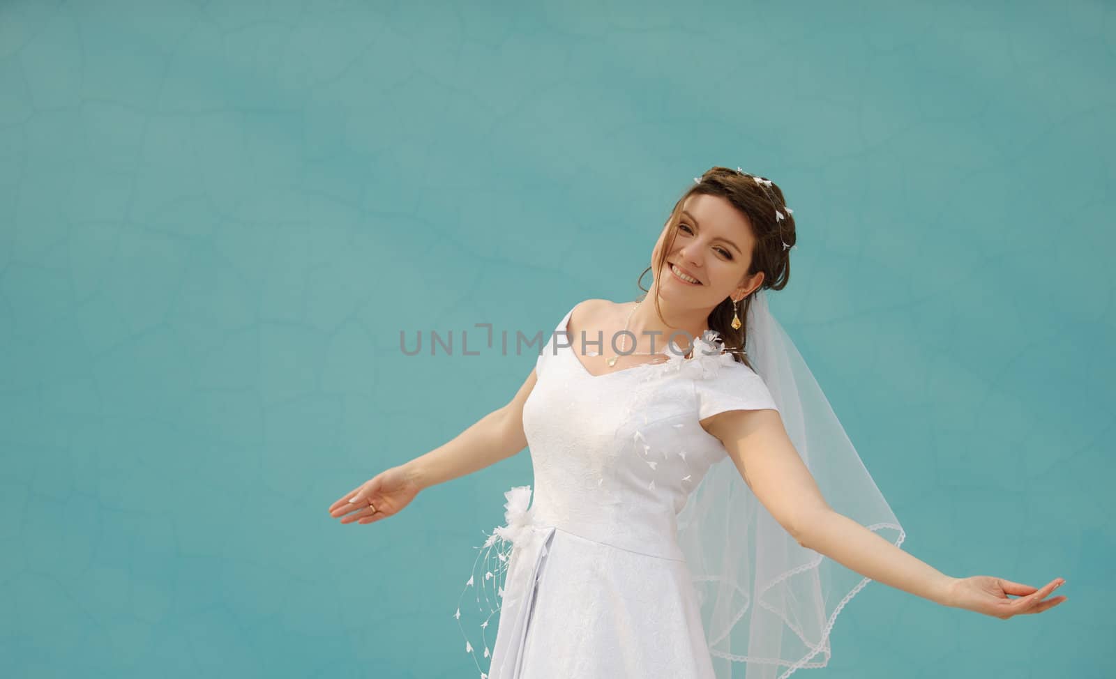 The dancing bride. The young girl in a wedding dress on an abstract background. East dance