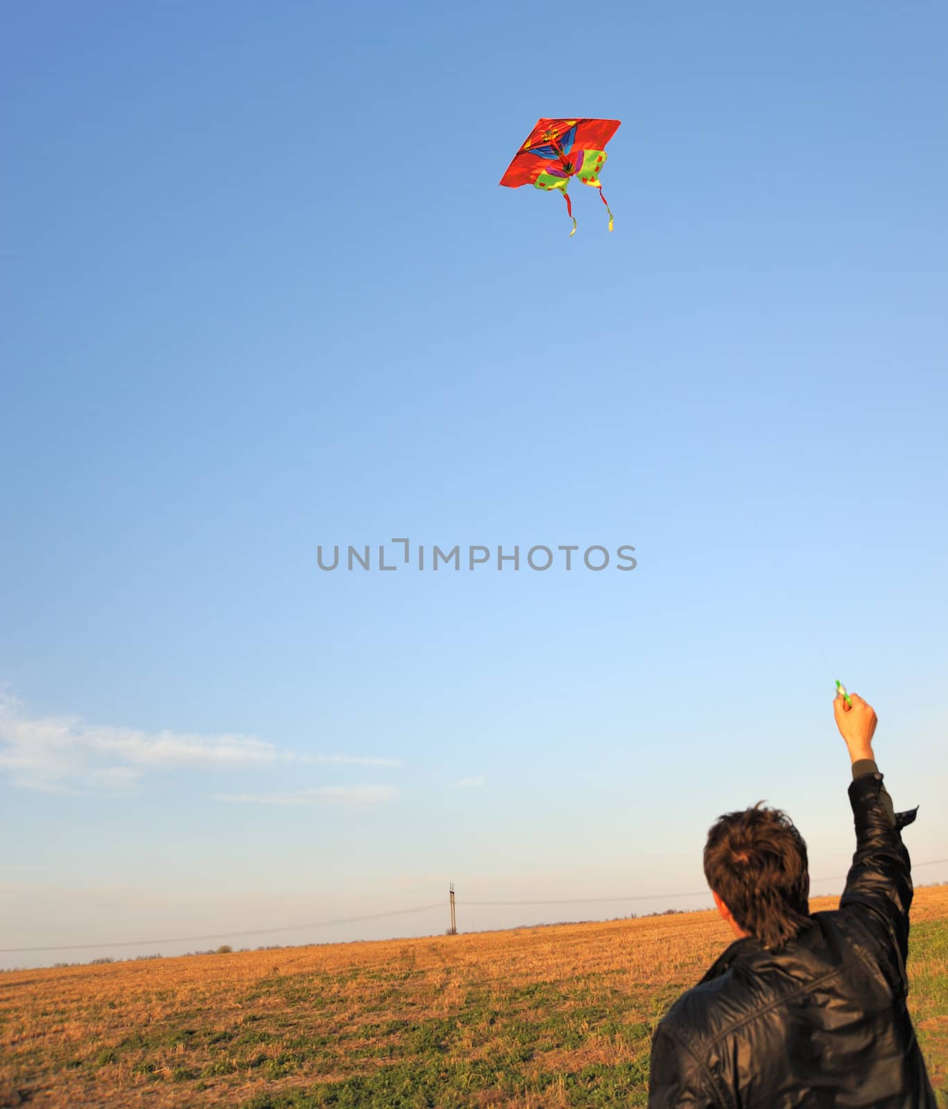 Kite. A colourful kite flying to the dark blue sky