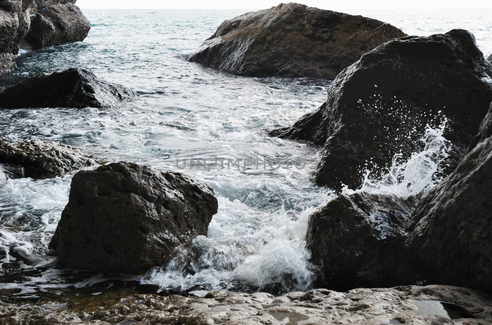 Splash of waves about coastal stones. Crimea, Ukraine