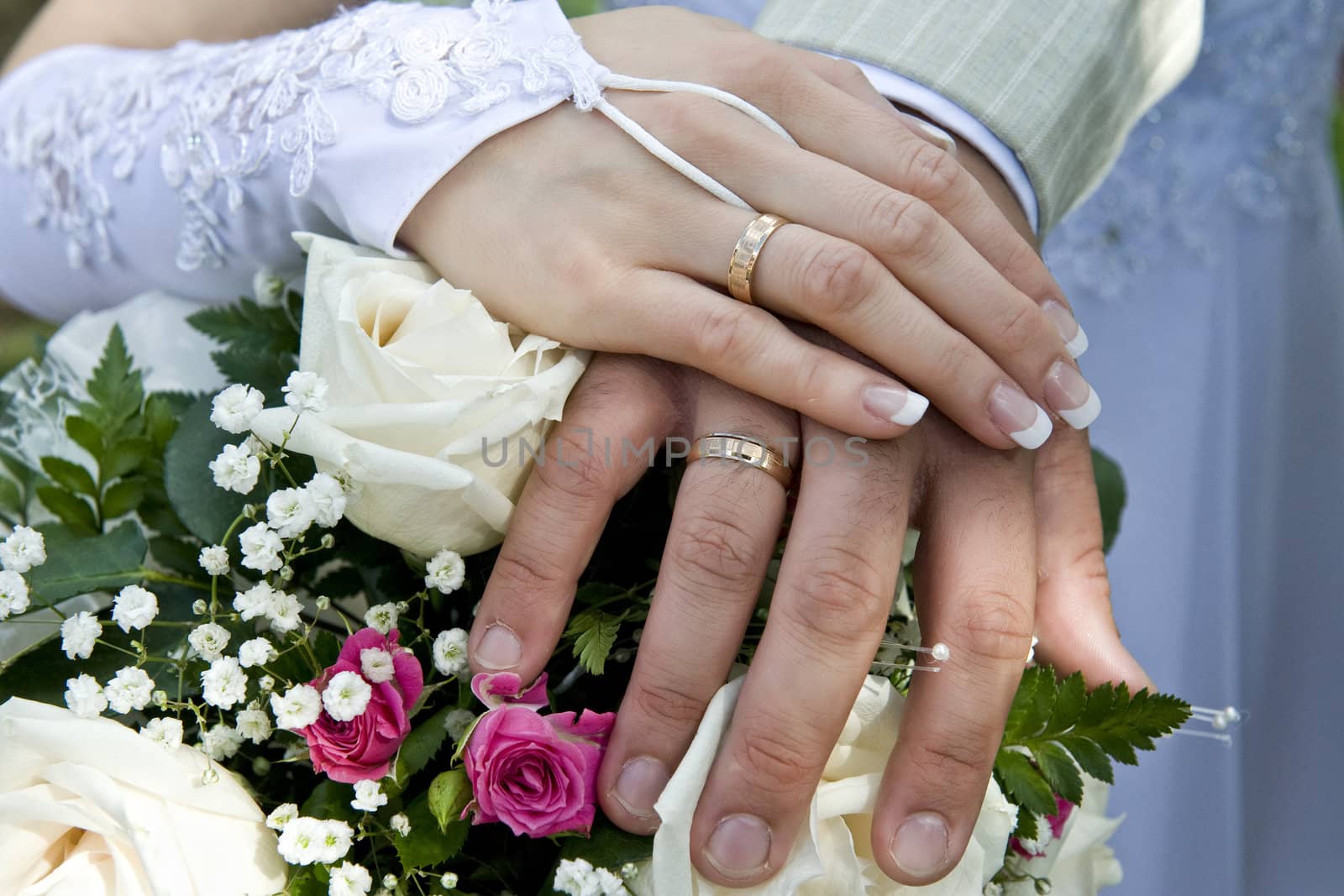 Hands of the groom and the bride with rings by Aleksandr