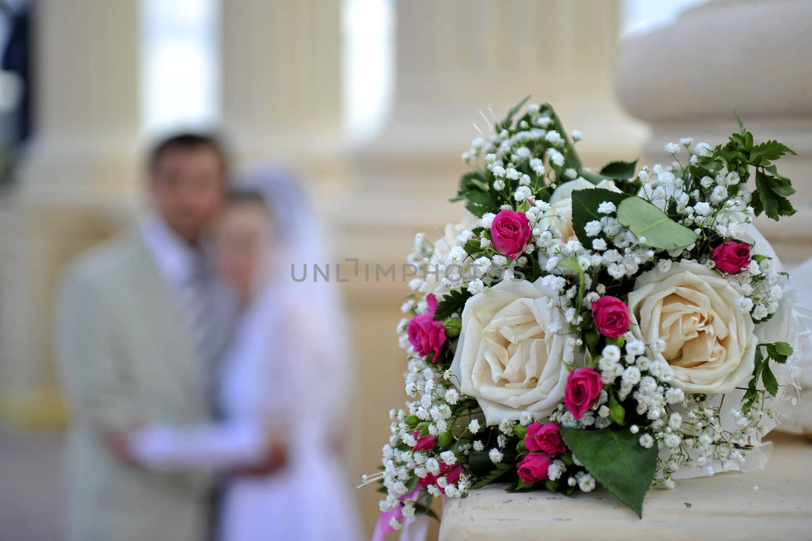 Wedding bouquet against the groom and the bride by Aleksandr