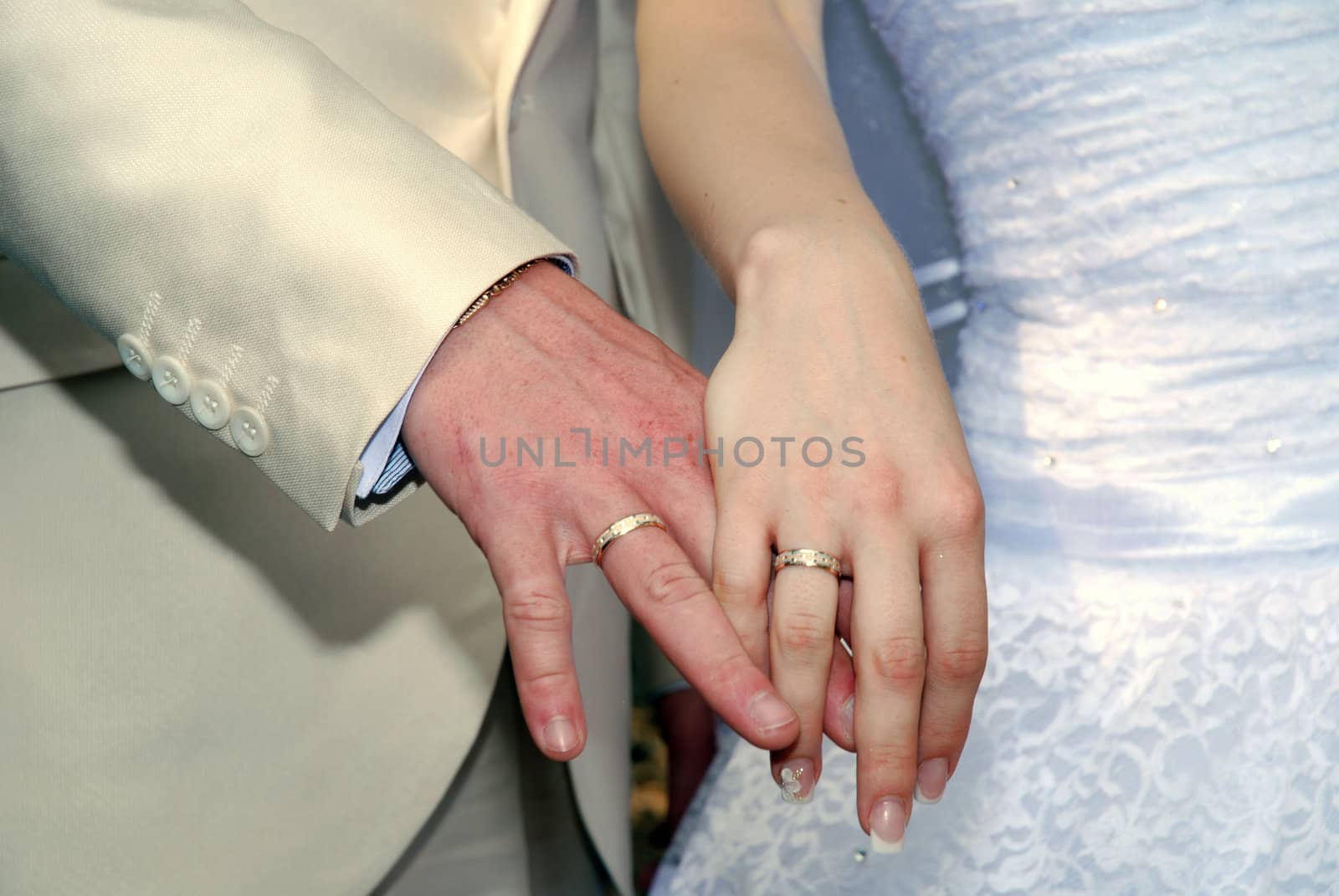 Hands of the groom and the bride with rings by Aleksandr